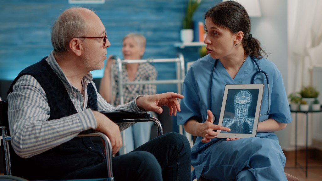 Doctor explaining brain scan results to an elderly patient on World Alzheimer’s Day